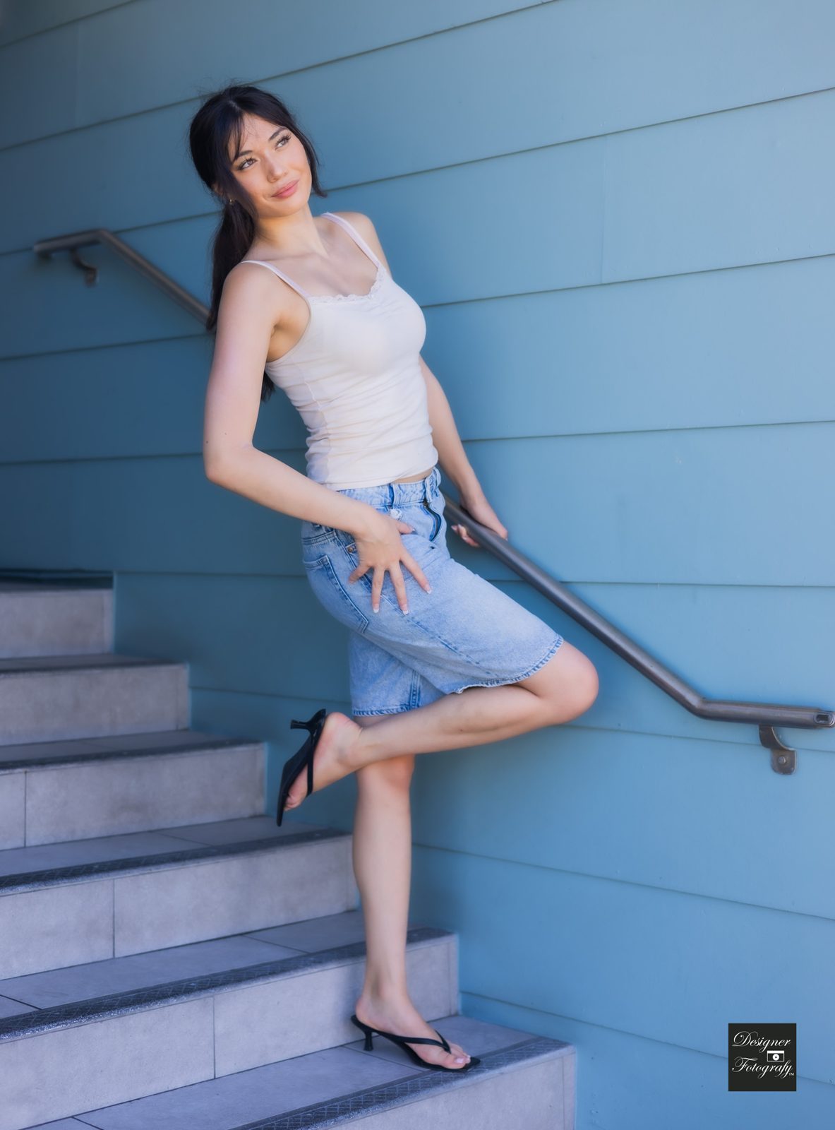 Posed against a blue wall